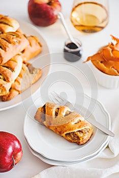 Apple cinnamon pastry rolls on white wooden table