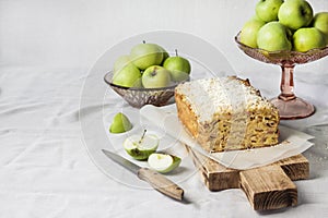Apple and coconut loaf cake on wooden cutting board