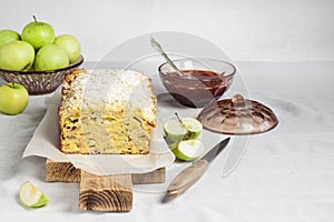 Apple and coconut loaf cake on wooden cutting board