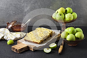 Apple and coconut loaf cake on wooden cutting board