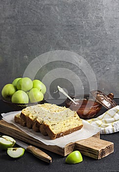 Apple and coconut loaf cake on wooden cutting board