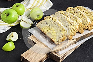 Apple and coconut loaf cake on wooden cutting board