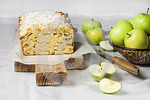 Apple and coconut loaf cake on wooden cutting board