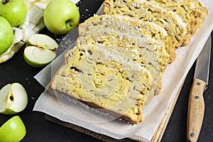 Apple and coconut loaf cake on wooden cutting board