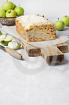 Apple and coconut loaf cake on wooden cutting board