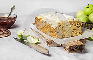 Apple and coconut loaf cake on wooden cutting board