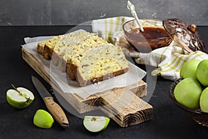 Apple and coconut loaf cake on wooden cutting board