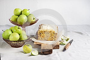 Apple and coconut loaf cake on wooden cutting board