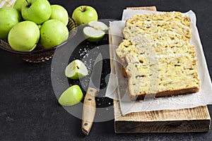 Apple and coconut loaf cake on wooden cutting board