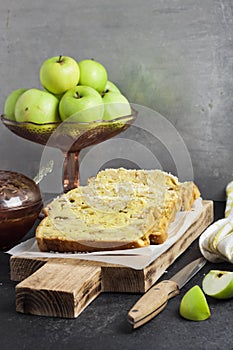 Apple and coconut loaf cake on wooden cutting board