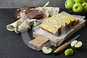 Apple and coconut loaf cake on wooden cutting board