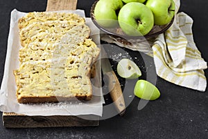 Apple and coconut loaf cake on wooden cutting board