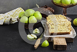 Apple and coconut loaf cake on wooden cutting board