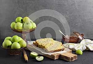 Apple and coconut loaf cake on wooden cutting board