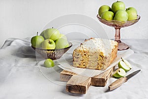 Apple and coconut loaf cake on wooden cutting board