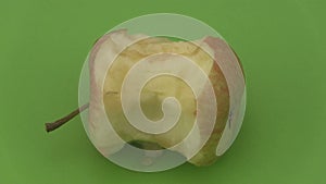 Apple core on a green background.