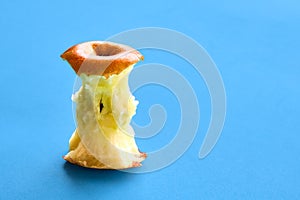 Apple core isolated on a light blue background.