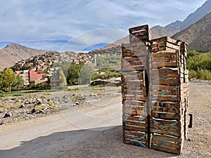 Apple crates with Imlil in the background. High Atlas Mountains, Morocco.