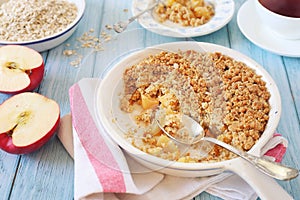 Apple crumble from oatmeal and cup of tea for healthy breakfast