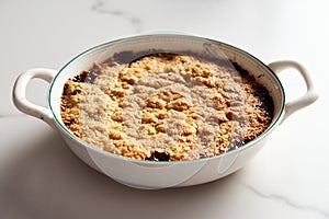 Apple Crumble Pie made from caramelized apples with spices. High-key photo, white marble background. breakfast concept