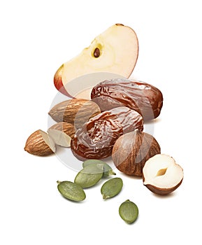 Apple, dates, almond, hazelnuts and pumpkin seeds isolated on white background