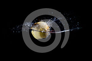 An Apple falls into the water on a black background