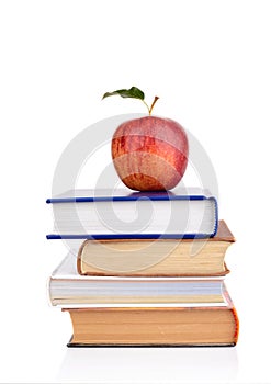 Apple on few school books on a white background photo