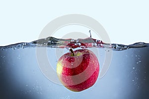 Apple fresh red splash into the water,red fruit