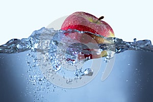 Apple fresh red splash into the water,red fruit