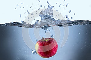 Apple fresh red splash into the water,red fruit