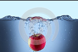 Apple fresh red splash into the water,red fruit food