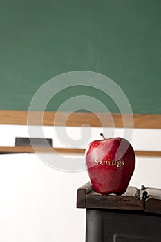 Apple in front of blackboard