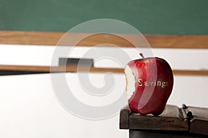 Apple in front of blackboard