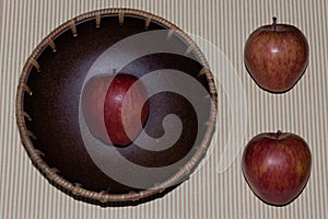 Apple on a fruit bowl over striped background