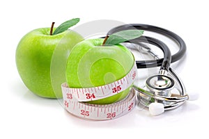 Apple fruits with measuring tape and medical stethoscope