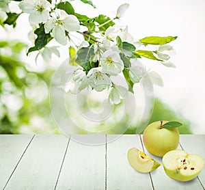 Apple fruits, wooden background, green leaves