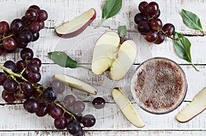 Apple-grapes drink on wooden table