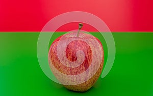 Apple on green and red background