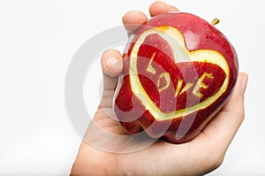 Apple,heart,love in woman hand isolate on white background