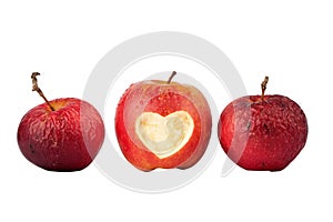 Apple with a heart symbol and two old apples