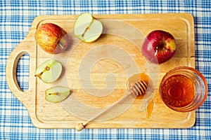 Apple and honey on wooden board. Jewish Rosh hashana (New Year) holiday celebration. View from above