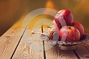 Apple and honey on wooden table for Jewish Rosh hashana (new year) celebration