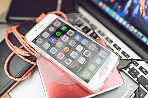 Apple iPhone 6S placed on Macbook Laptop