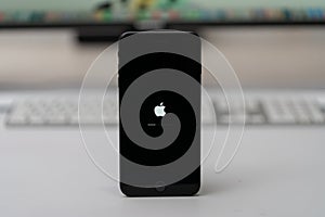 Apple iPhone updated iOs, apple icon and status bar on screen, selective focus