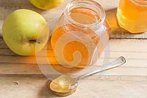 Apple jelly jam on wooden table with apples - selective focus on