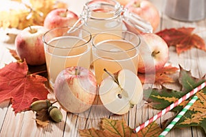 Apple juice, apples and maple leaves