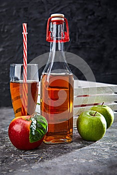 Apple juice in glass bottle and cup