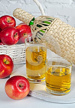 Apple juice in glasses and apples