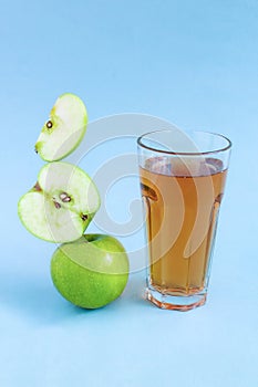 Apple juice levitation. Balance food levitate conceptual creative still life. Balance of fresh green apple slices and a