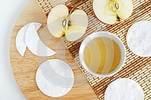 Apple juice vinegar, handmade cotton eye patches and cotton pads Ingredients for preparing homemade mask or face toner.